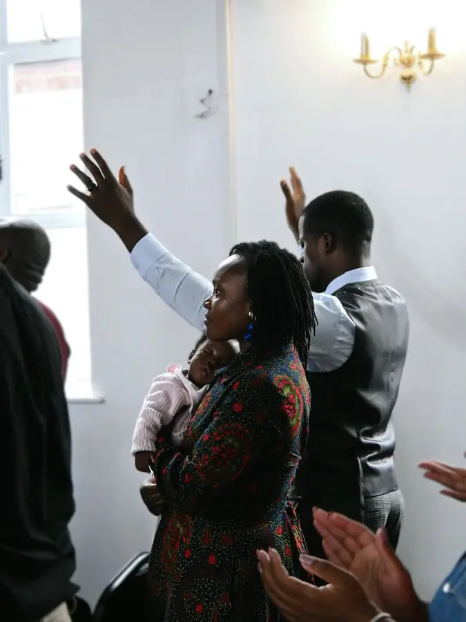 A woman raising her hand in worship