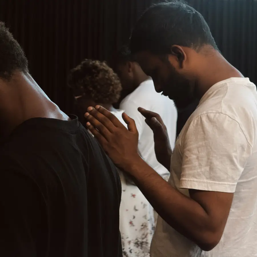 Two men praying with hands together